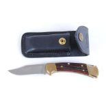 Clasp knife with 3 ins lock blade stamped Buck 112 USA, brass mounts, Rosewood grips, leather pouch