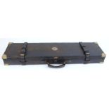 Oak and leather gun case with brass corners and central brass escutcheon, fitted interior in pale