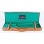 Tan leather gun case with combination lock, green baize lined interior for 28 ins over and under