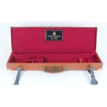 Tan leather gun case with brass mounts, claret coloured baize lined interior for 28 ins barrels, AYA