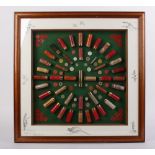 Framed and glazed cartridge display board, mostly 12 boore paper cased by Holland & Holland,