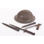 WW II Brodie pattern steel helmet with two bayonets