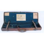 Oak and leather motor case with part fitted green baize interior for 28 ins barrels, Holland &