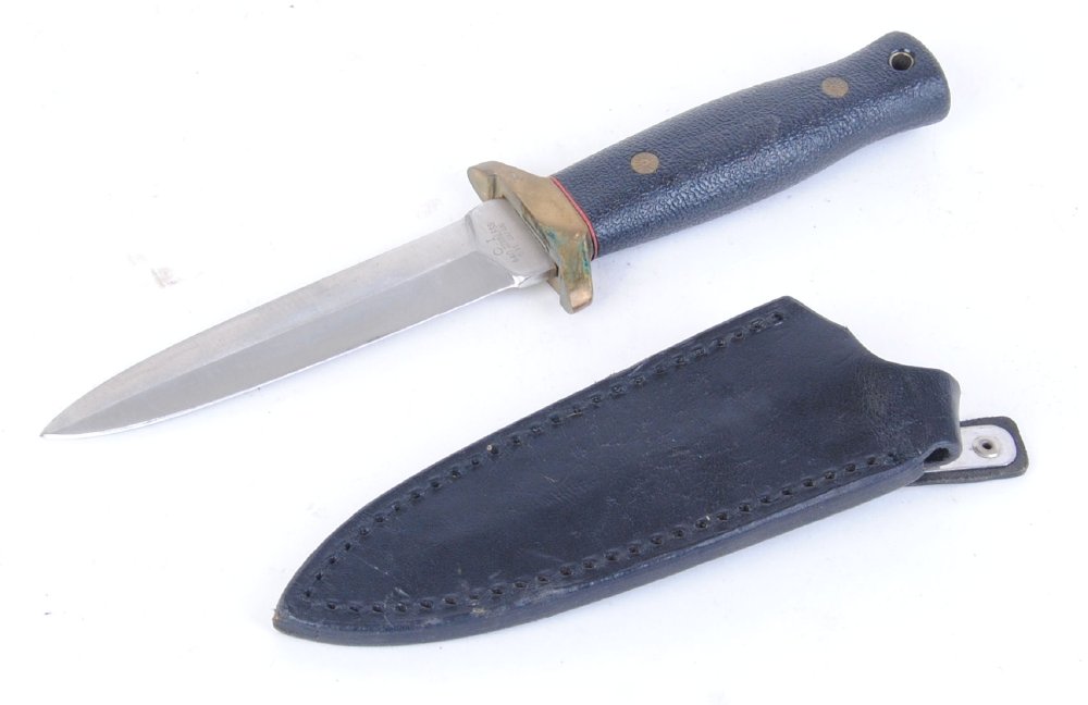 Boot knife with 4 ins double edged blade, brass crossguard, spring clip sheath