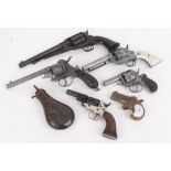Six replica pistols, .44 Colt, Remington, etc. and a powder flask. This Lot is offered for the