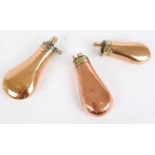 Three copper and brass pistol flasks, 3,3/4 ; 4,1/8; 4,3/4 ins