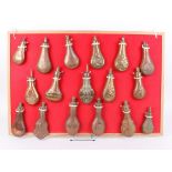 Display board with seventeen decorative copper and brass powder and shot flasks