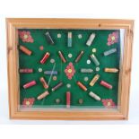 Glazed cartridge display board with .410, 28 and 12 bore cartridges including, Wizzard, Eley