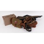 Canvas and leather cartridge bag, four leather cartridge belts, ammo box, gun slip