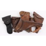 Two Sam Browne holsters stamped 1915 and 1917; Bloomberg holster; shoulder holster stamped 1944