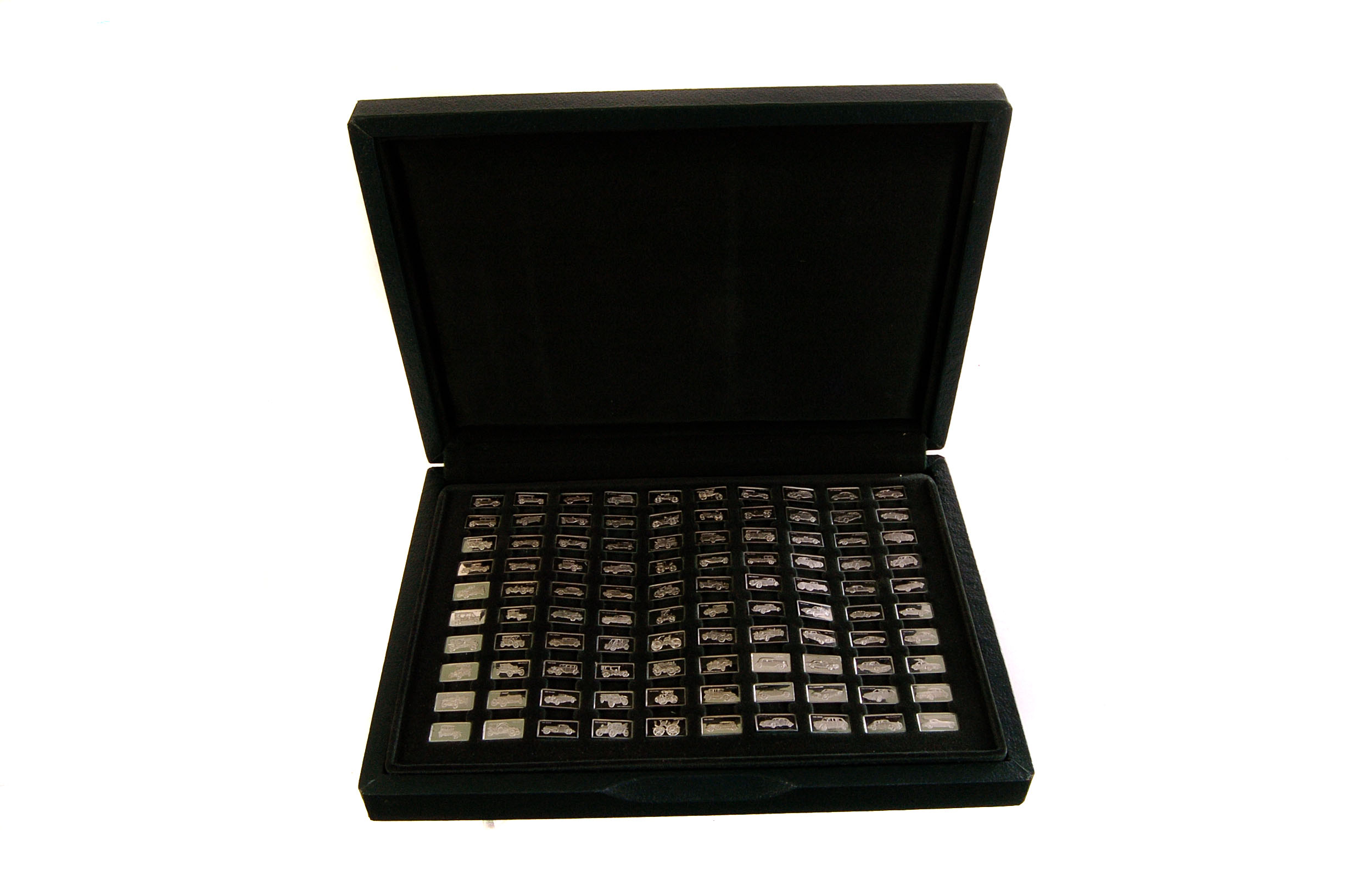 A group of 100 miniature greatest car silver ingots, in case with information book, by John