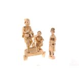 A late Meiji Tokyo school carved ivory group of father and son, signed, together with a similar