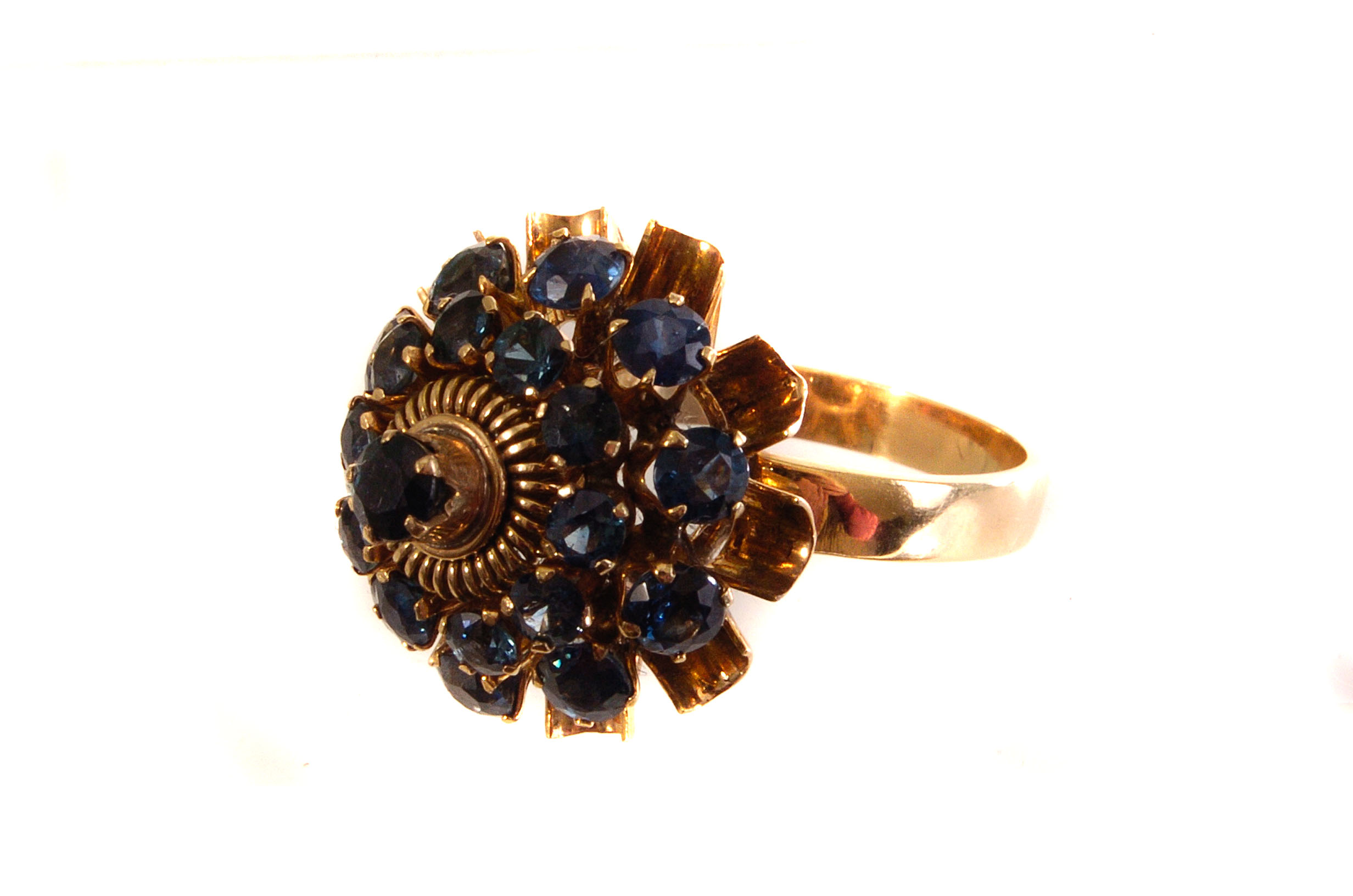 An 18ct gold and sapphire cluster dress ring, the graduated blue round cut sapphires in claw mounts,