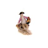 A 19th century Meissen porcelain figure, of a seated man holding a hen and a basket of flowers, with