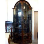 A 19th century Japanese bow fronted display cabinet, having Japanese lacquered decoration of various