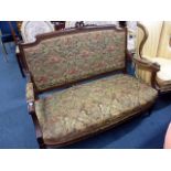 A French walnut framed sofa, with rose and ribbon cartouche surmounting a gadrooned back rail,