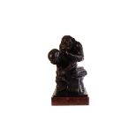 A spelter figure of Darwin's Monkey, the monkey sitting on a stack of books thinking while looking