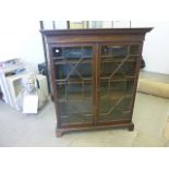 A mahogany display cabinet, with astroglaze design, revealing three adjustable shelves, approx 133cm