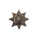 A Victorian silver military chest badge, in the form of a star with central fusiliers horn and stags
