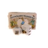 A four piece Peter Rabbit Nursery set by Wedgwood, together with a Wedgwood Peter Rabbit cup and