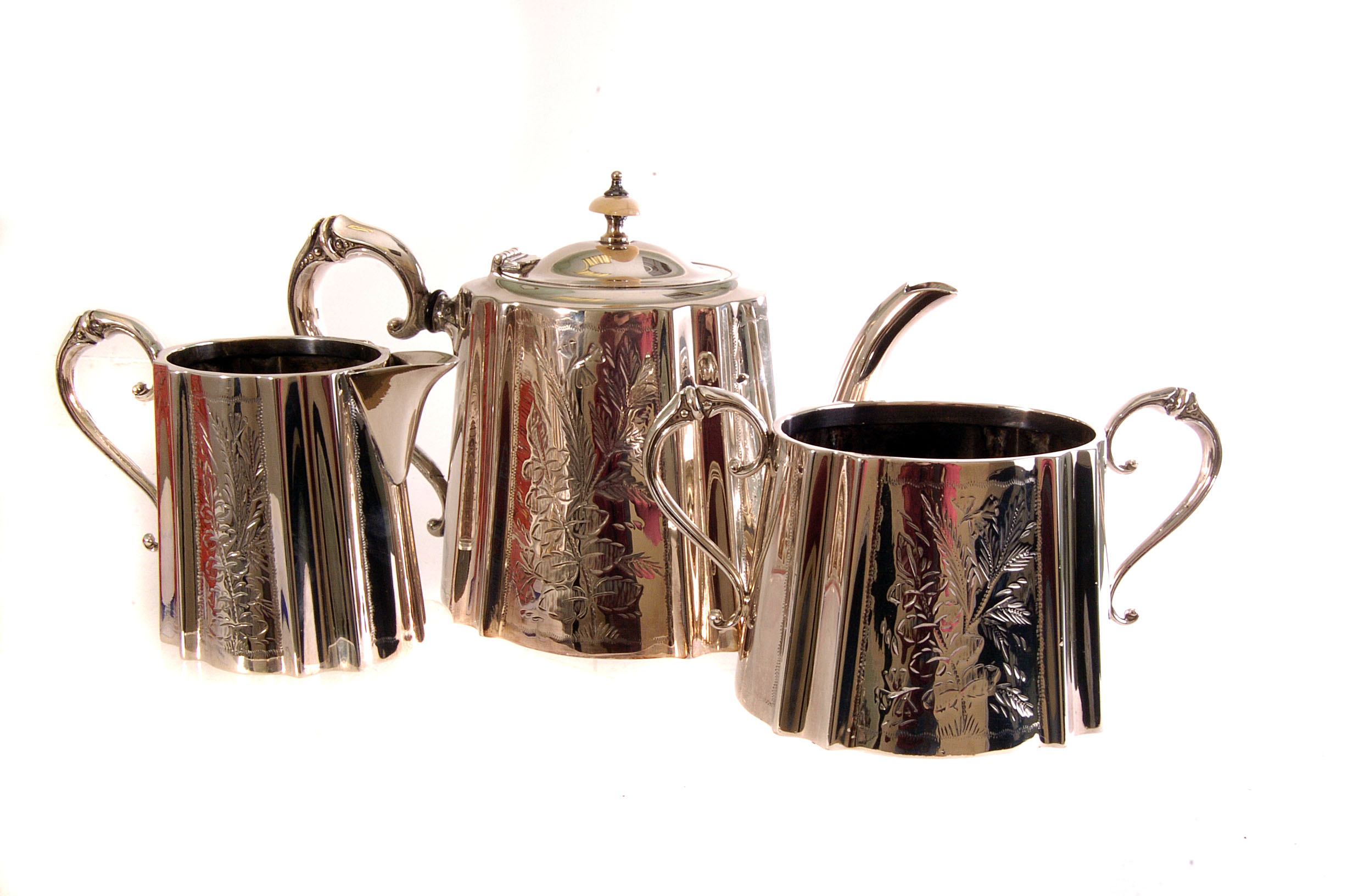 A silver plated three piece tea set, having floral engraved design, together with two plated basting
