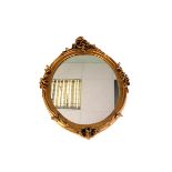 Two oval gilt paint mirrors, the two oval mirrors in florally decorative gilt frames (2)