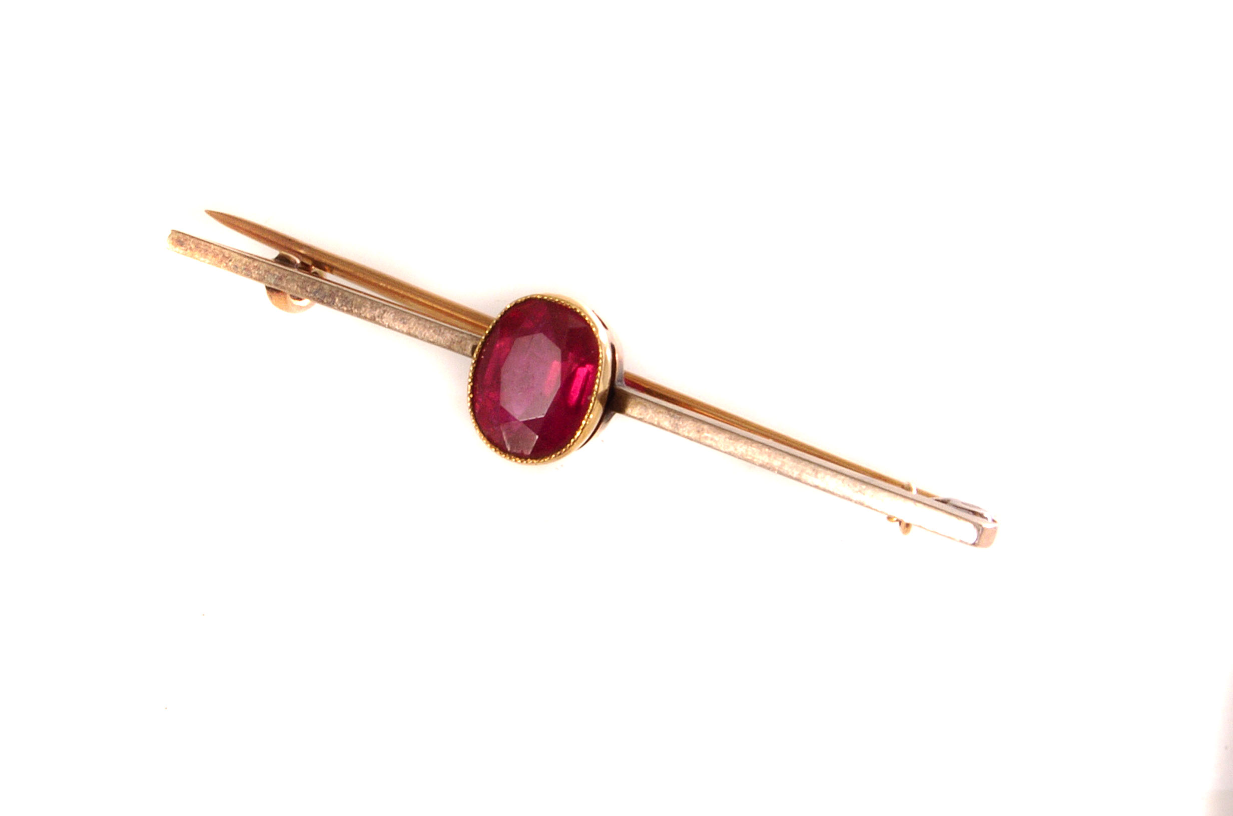 A gold and red gem stone bar brooch, the cushion cut red stone mounted in gold (1)