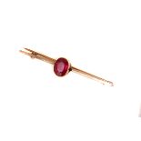 A gold and red gem stone bar brooch, the cushion cut red stone mounted in gold (1)