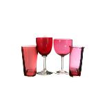 A collection of cranberry glasses, different styles, including one with florally etched glass (