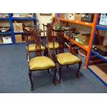 A set of four mahogany dining chairs, having pierced fret back, upholstered seats, on shaped legs,