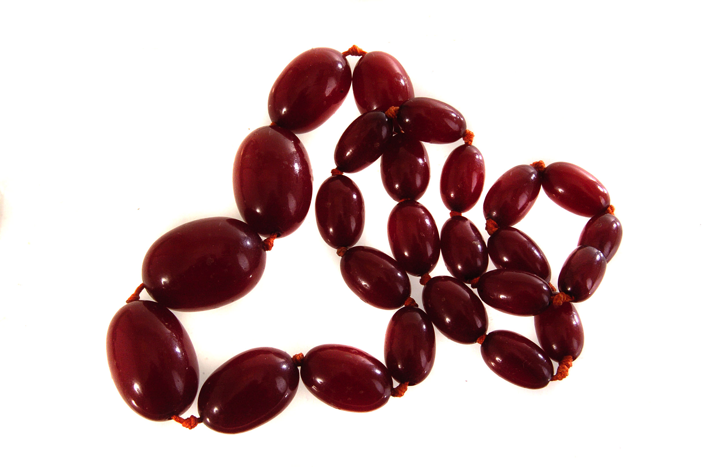 A string of cherry amber beads, of graduated size, approx 34.1g