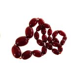 A string of cherry amber beads, of graduated size, approx 34.1g