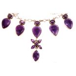 A silver and amethyst necklace, the various cut amethyst stones set in 925 grade silver, having five