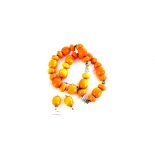 A faux amber bead necklace and earrings, the beeswax colour faux amber beads, with white metal