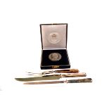 A silver plated and steel carving set, together with a white metal King Husseini medal in fitted