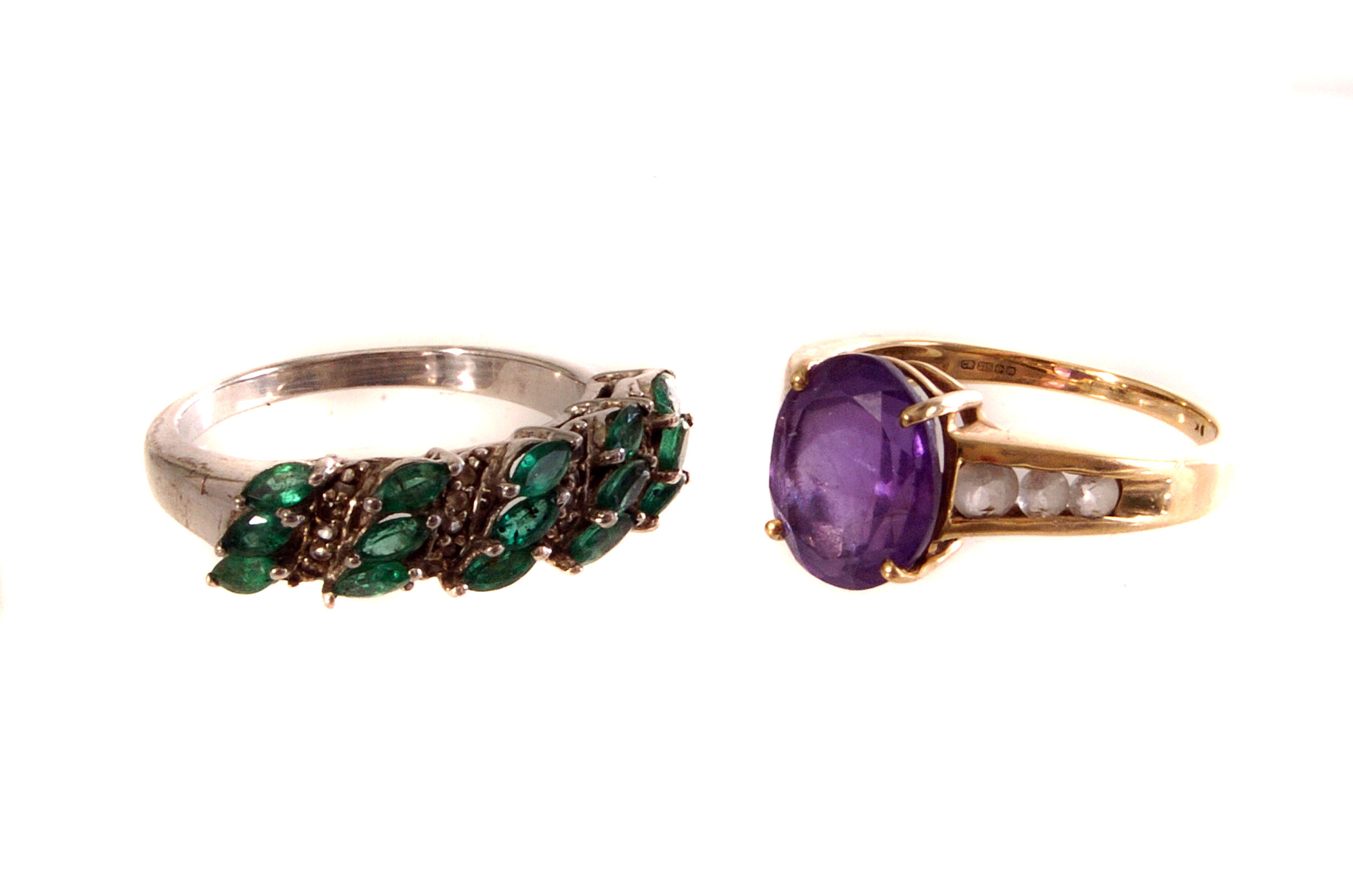 A 9ct gold amethyst and topaz dress ring, together with a silver emerald and topaz ring, both in