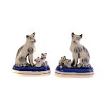 A pair of soft pastel porcelain cat groups, possibly Samson, both of cat with two kittens, marked to