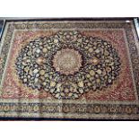 A blue ground Keshan carpet, having central floral medallion, with decorative multi-border, approx