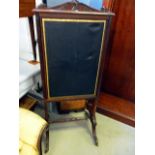 A William IV extending mahogany fire screen, with tooled leather panels, supported on twin pillar