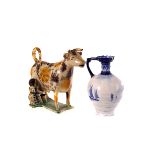 A Wealdon ceramic cow creamer, AF, together with a Royal Crown Derby blue and white bottle vase with