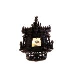 An Indonesian carved wooden wall mirror, having numerous carved figures or religious figures and