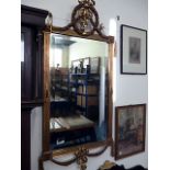 An early 20th century bevelled edge gilt framed mirror, with ribbon cartouche and decorated with