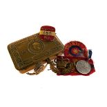 A collection of WWI and WWII cap badges, together with a selection of cloth badges, flags, 1945