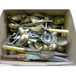 A collection of silver plated flatware, including sugar nips, carving items, spoons, a tea
