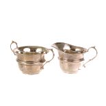 A George V silver twin handled sugar bowl, together with a George V silver milk jug, both marked