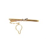 An 18ct gold and sapphire bar brooch, the square cut blue stones set in 18ct gold with white metal