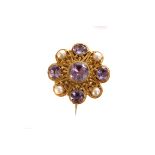 An Amethyst and pearl filigree brooch, with round cut amethysts and half cut pearls set in a gilt