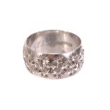 A thick platinum band, with repetitive engraved floral design, approx 8.8g, size M1/2