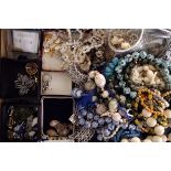 An assortment of various costume jewellery, to include bangles, necklaces, brooches, rings,