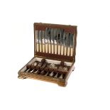 A 1930s oak canteen of silver plated flatware, comprising table spoons, tea spoons, knives and forks